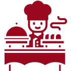 Icon of a chef standing behind a table with a cloche and three covered dishes, exuding steam, in a red silhouette style.