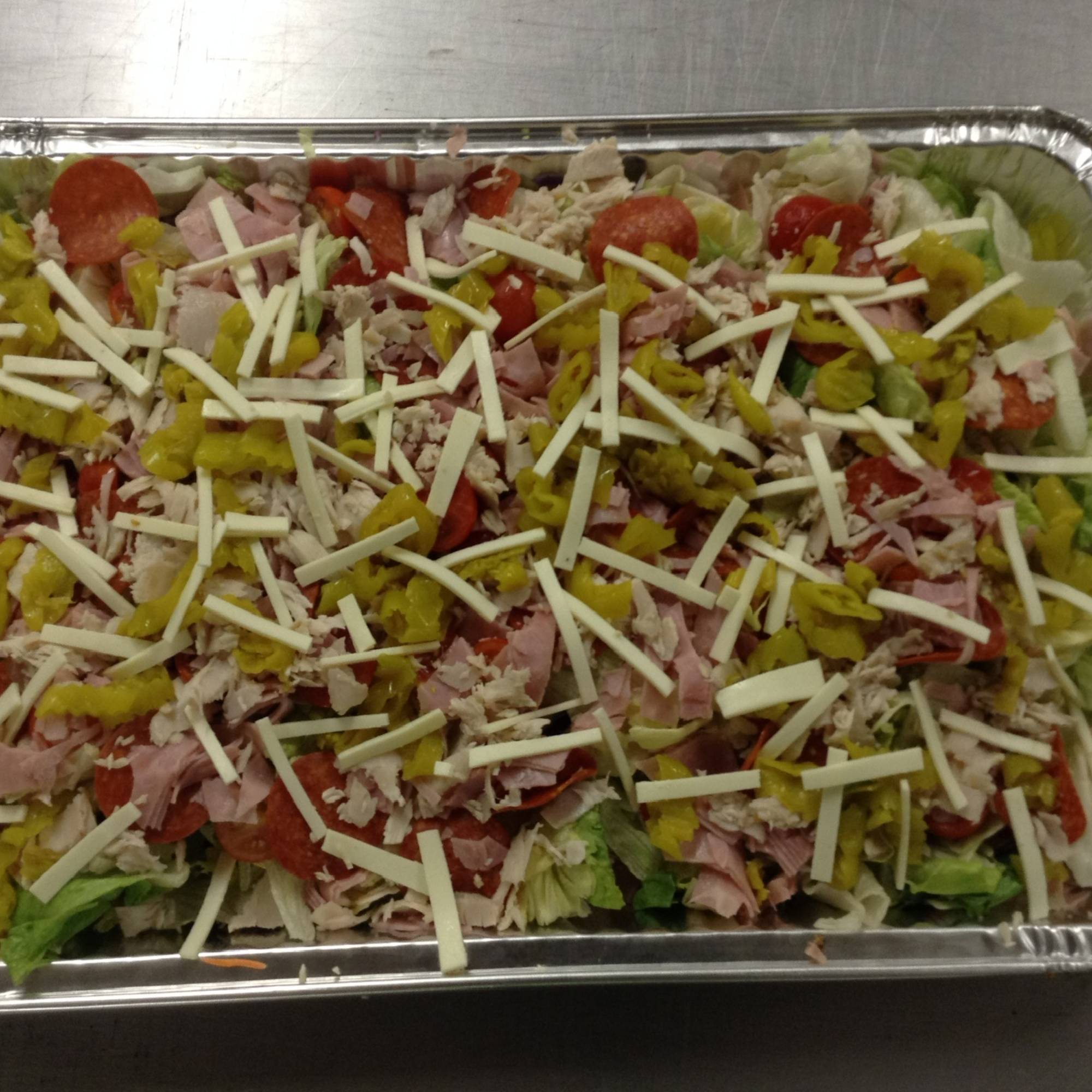 A tray of food with cheese and tomatoes on top.