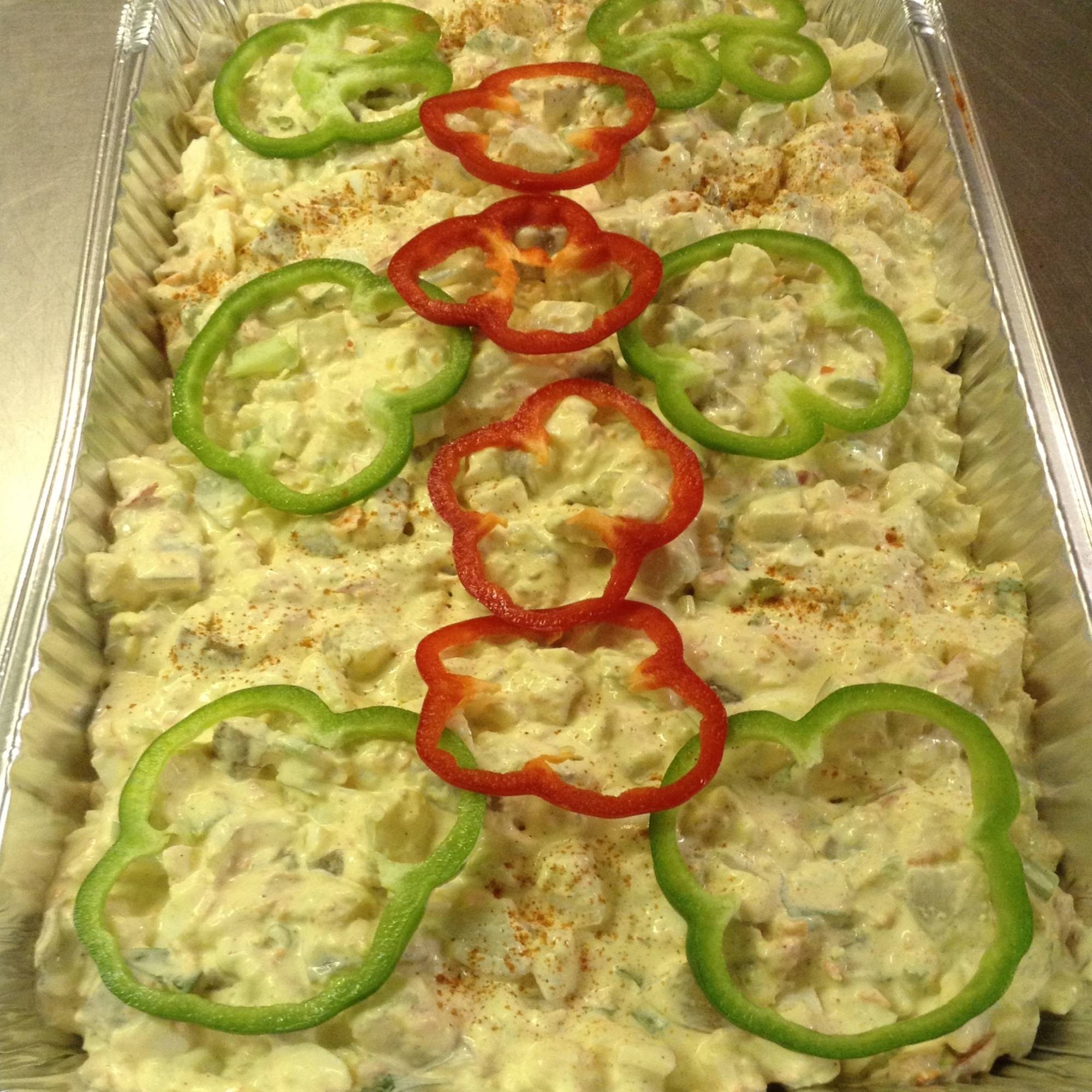A tray of food with peppers on top.