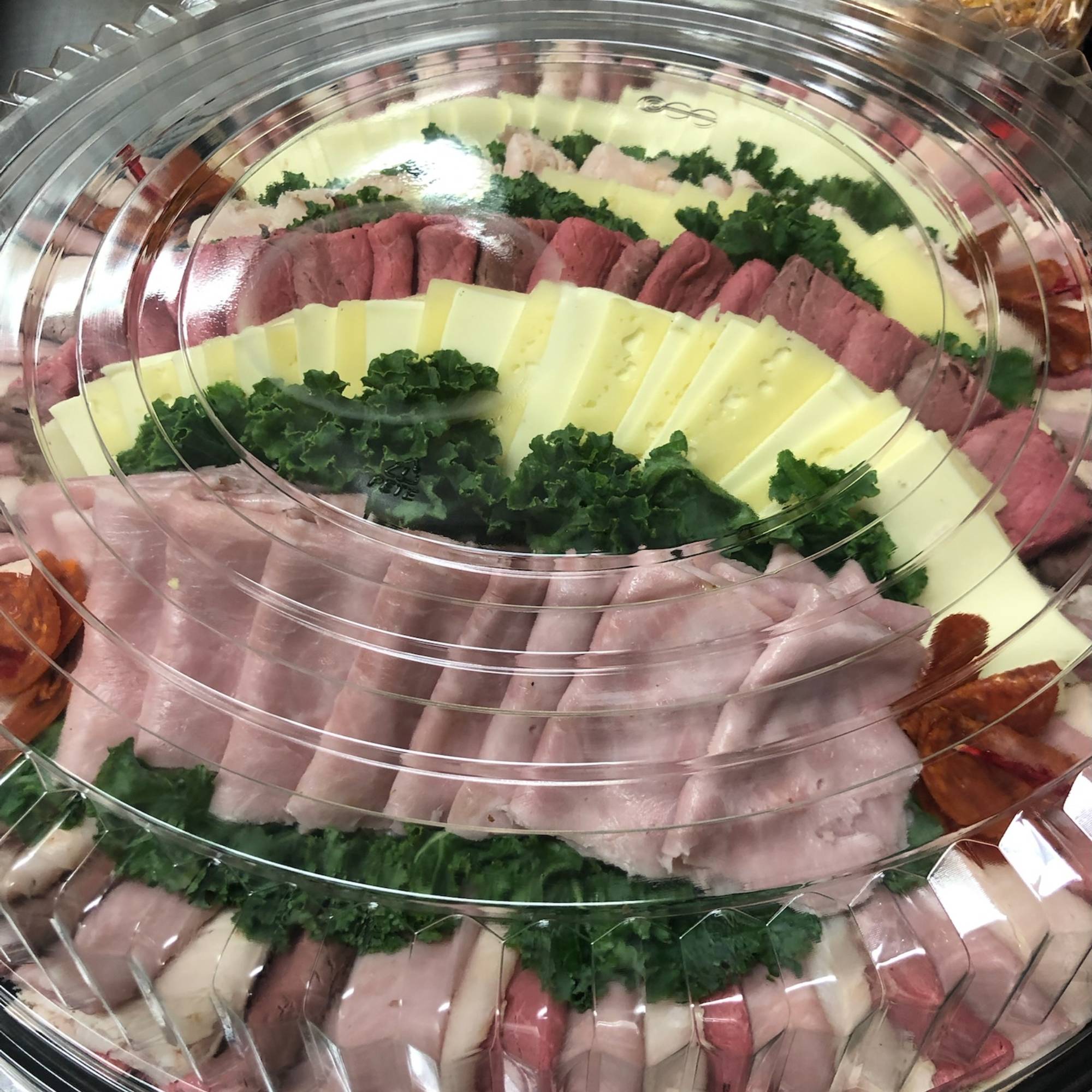 A platter of meat and vegetables on top of a table.