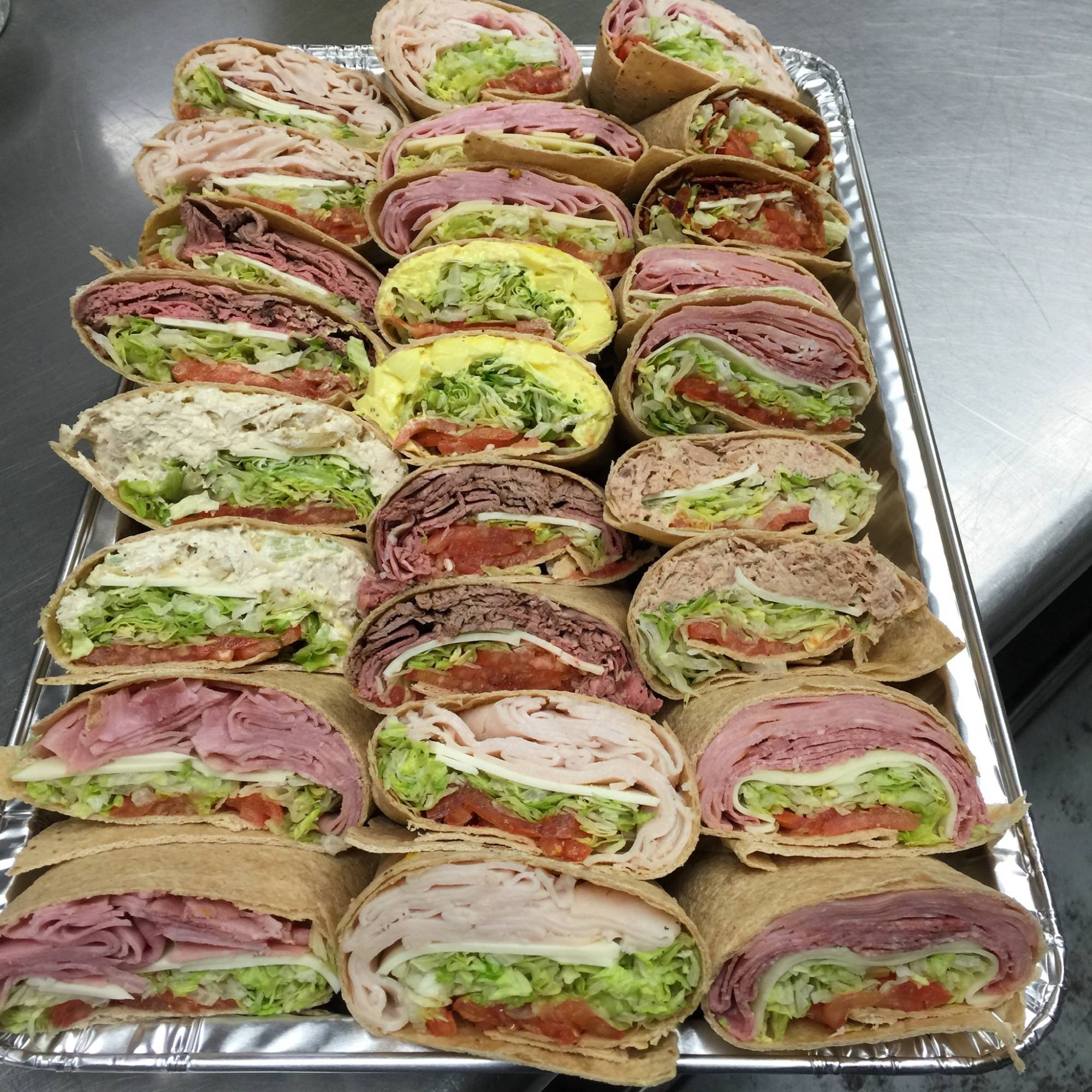 A tray of sandwiches on top of a table.