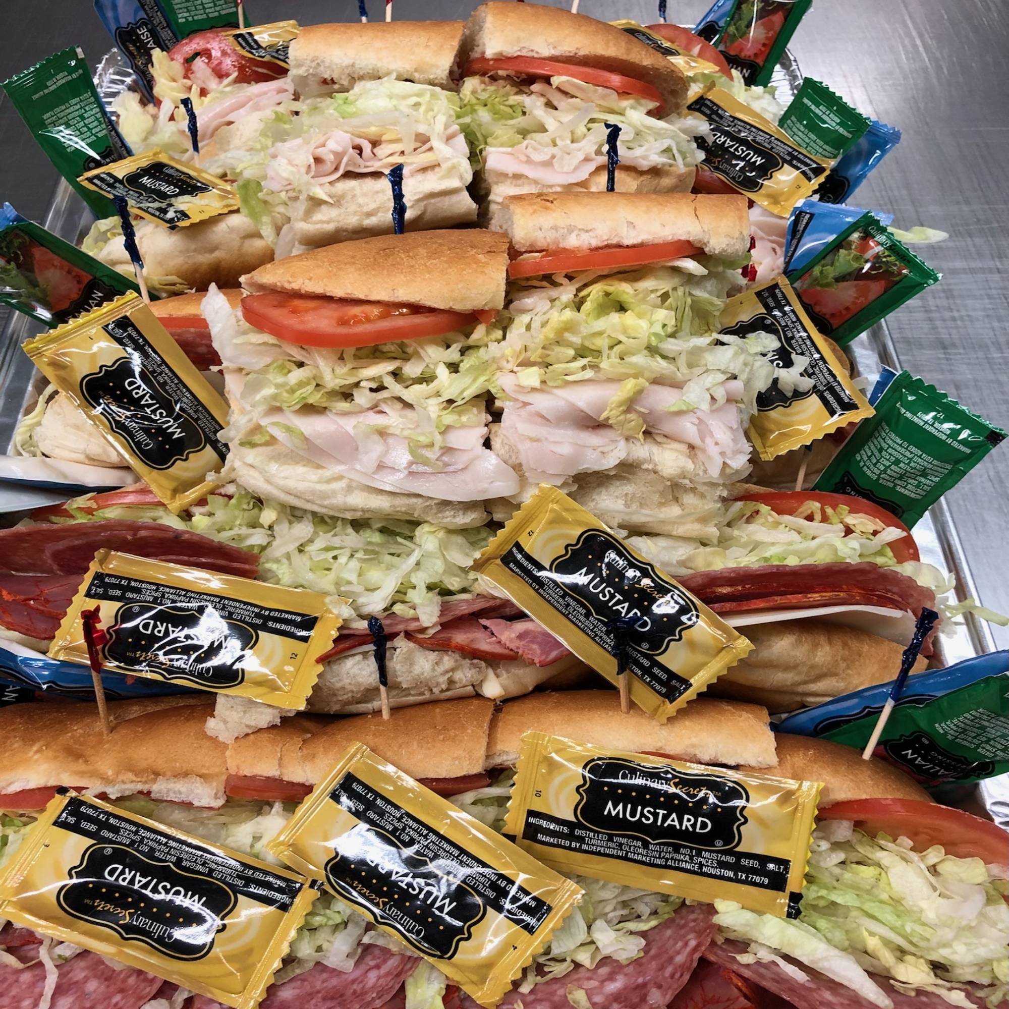 A large sandwich platter with many sandwiches on it