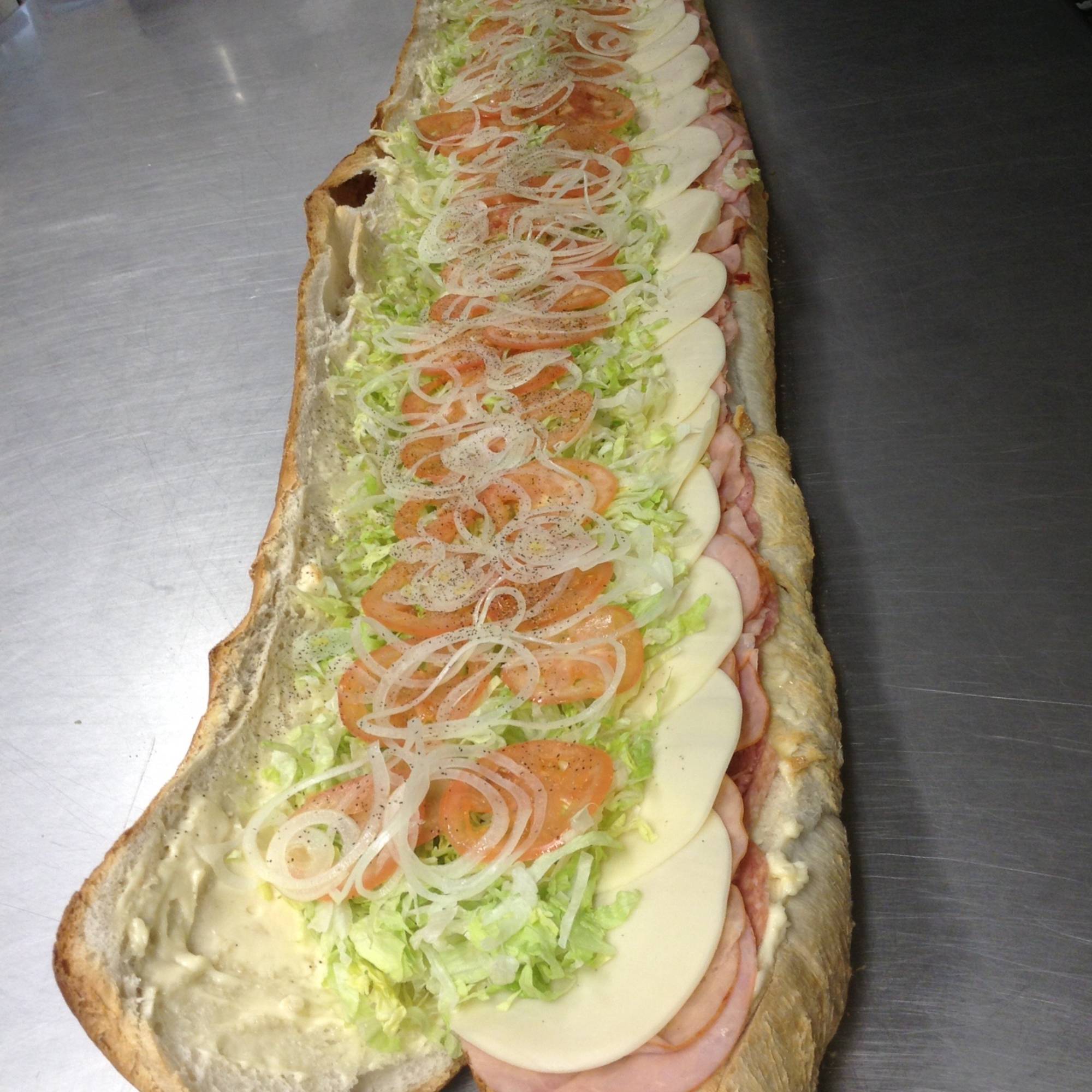 A large sandwich with many different toppings on it.