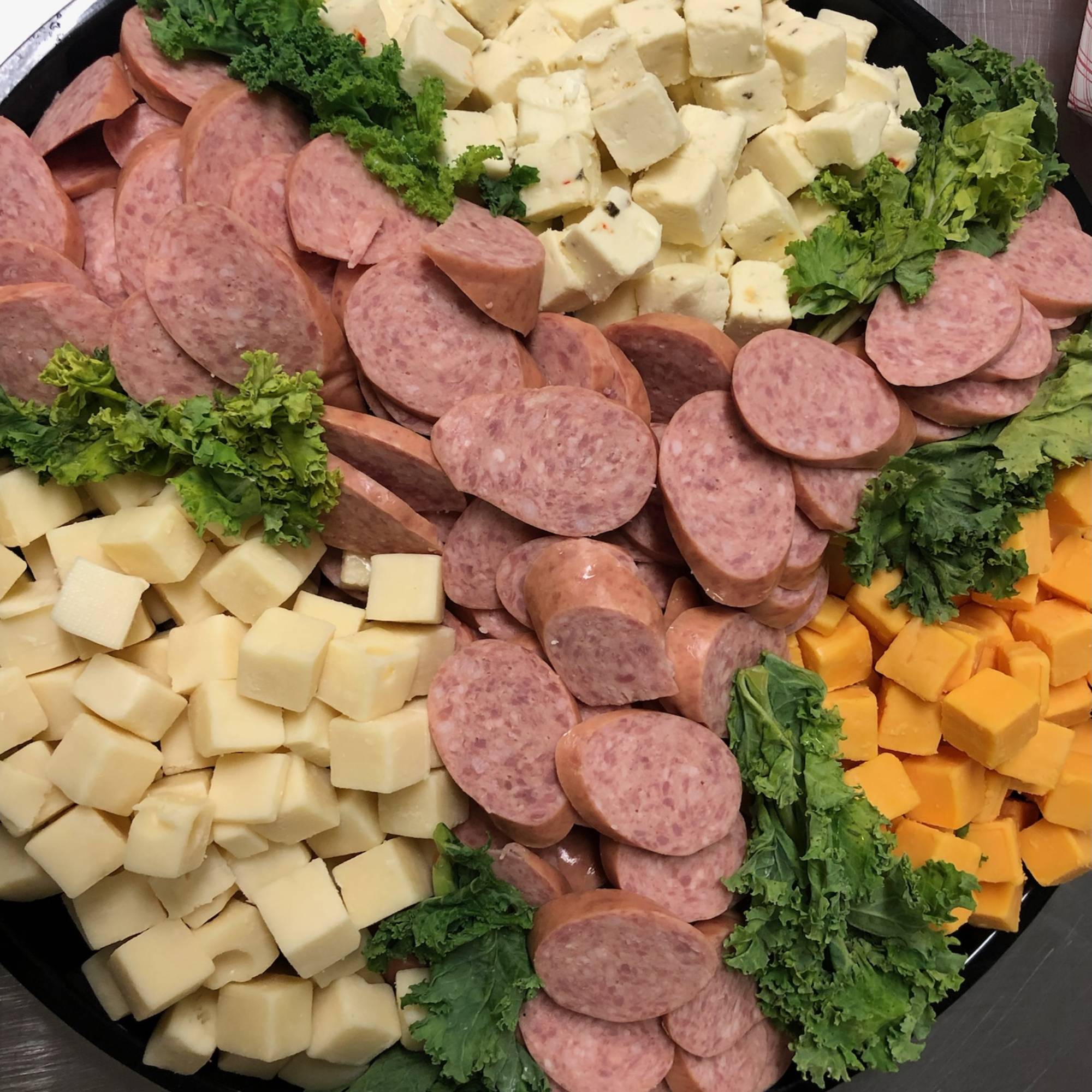A platter of sausage, cheese and other meats.
