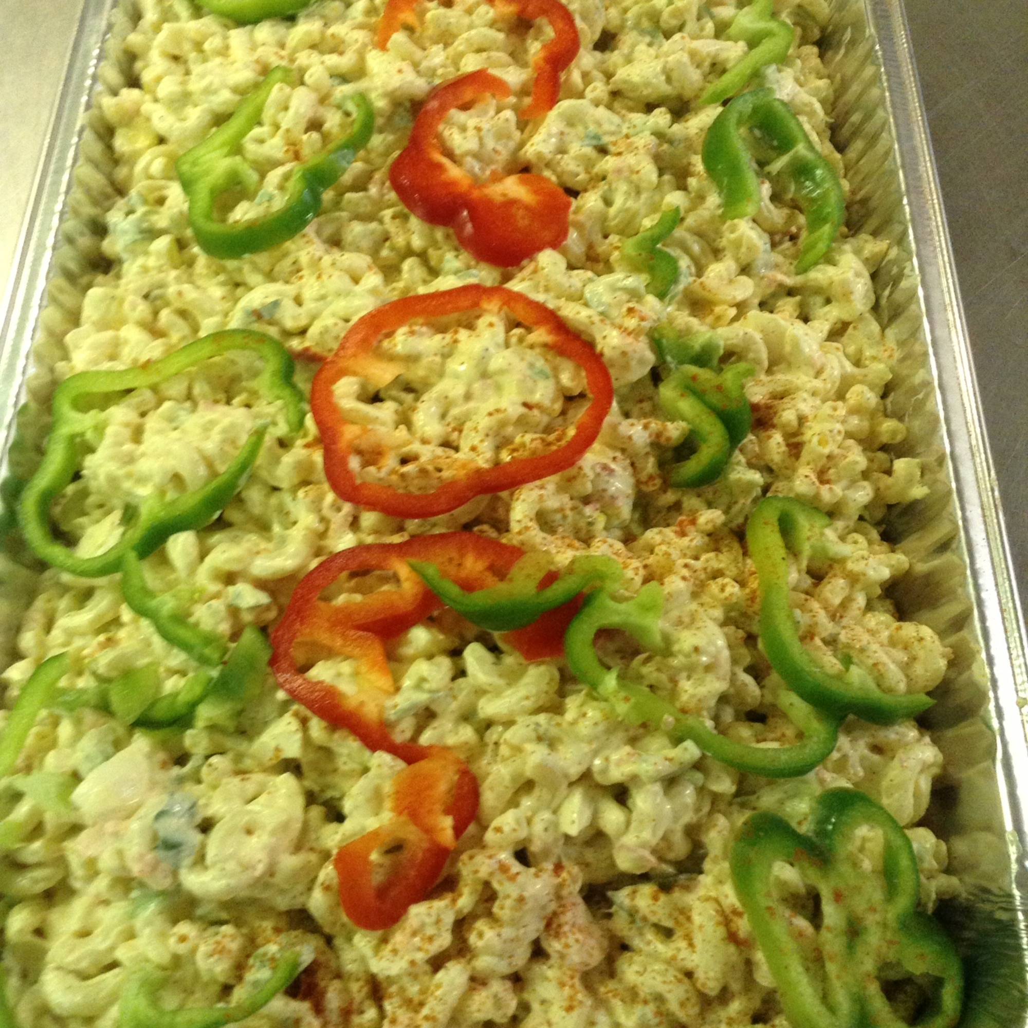 A tray of rice and peppers on top of the table.