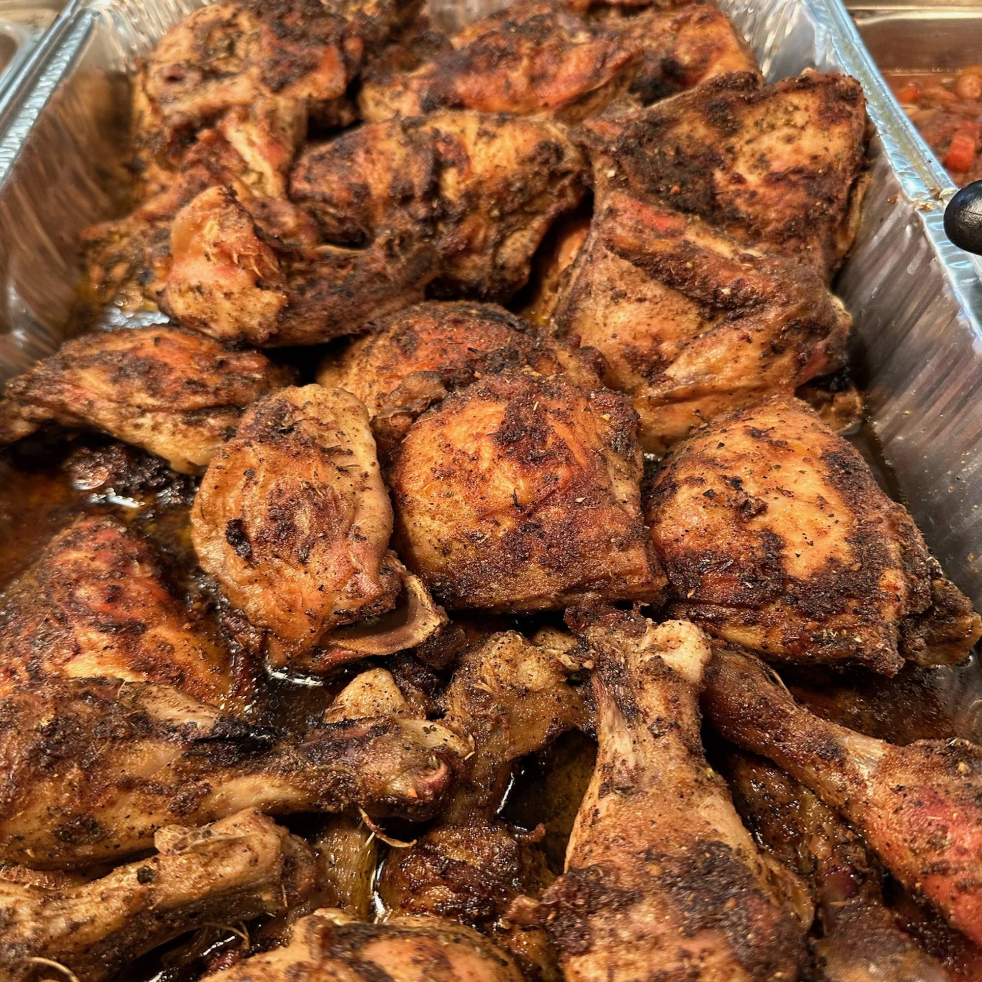 A pan of chicken is sitting on the table.
