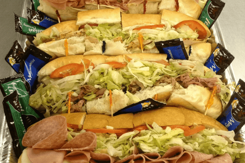 A large sandwich platter with many different sandwiches.
