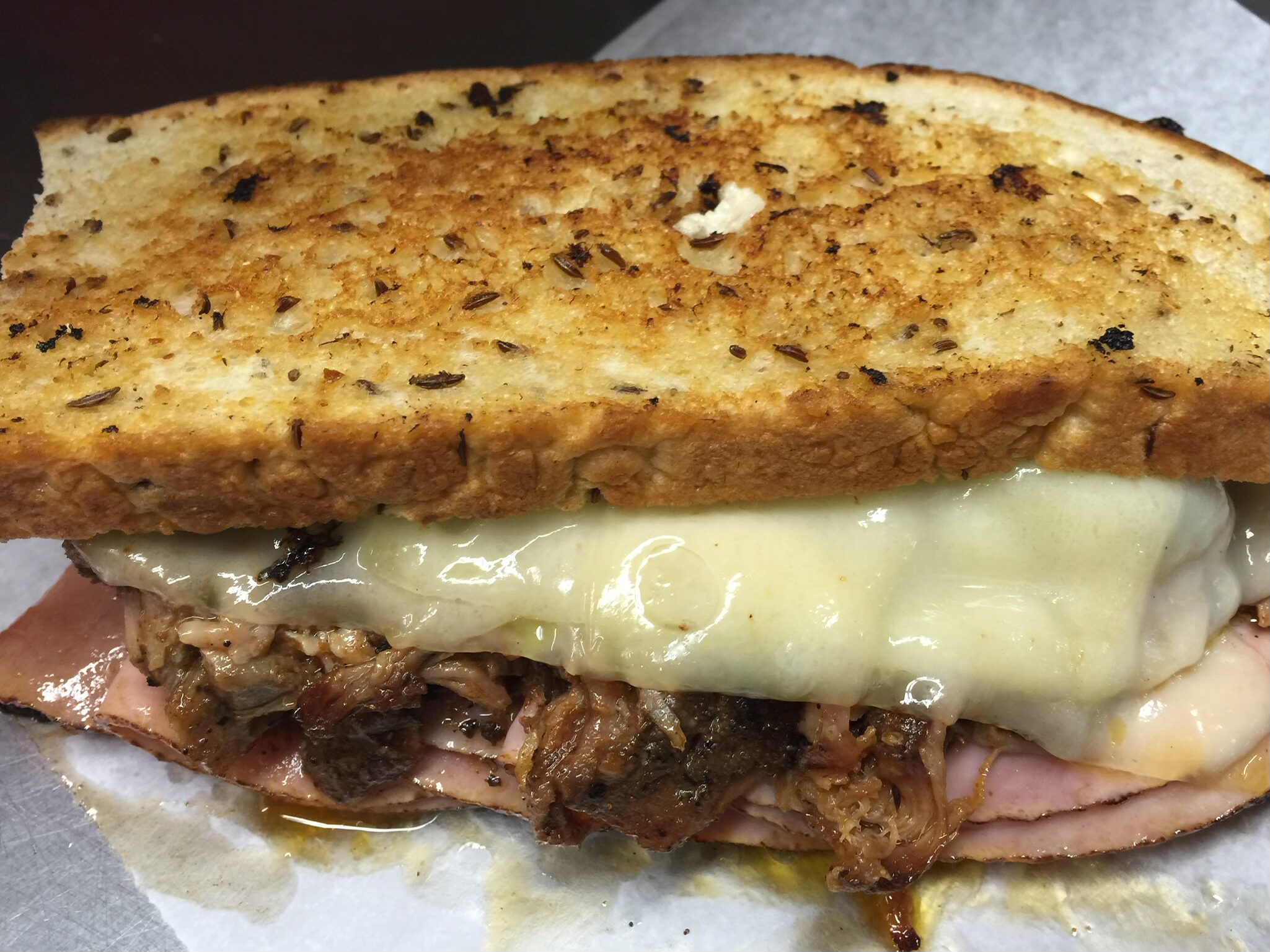 A sandwich with meat and cheese on it.
