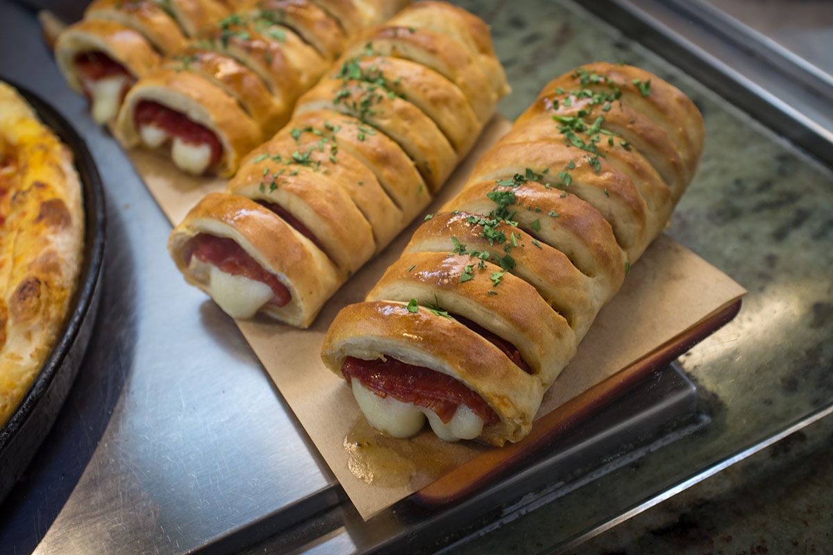 A tray of hot dogs wrapped in dough.