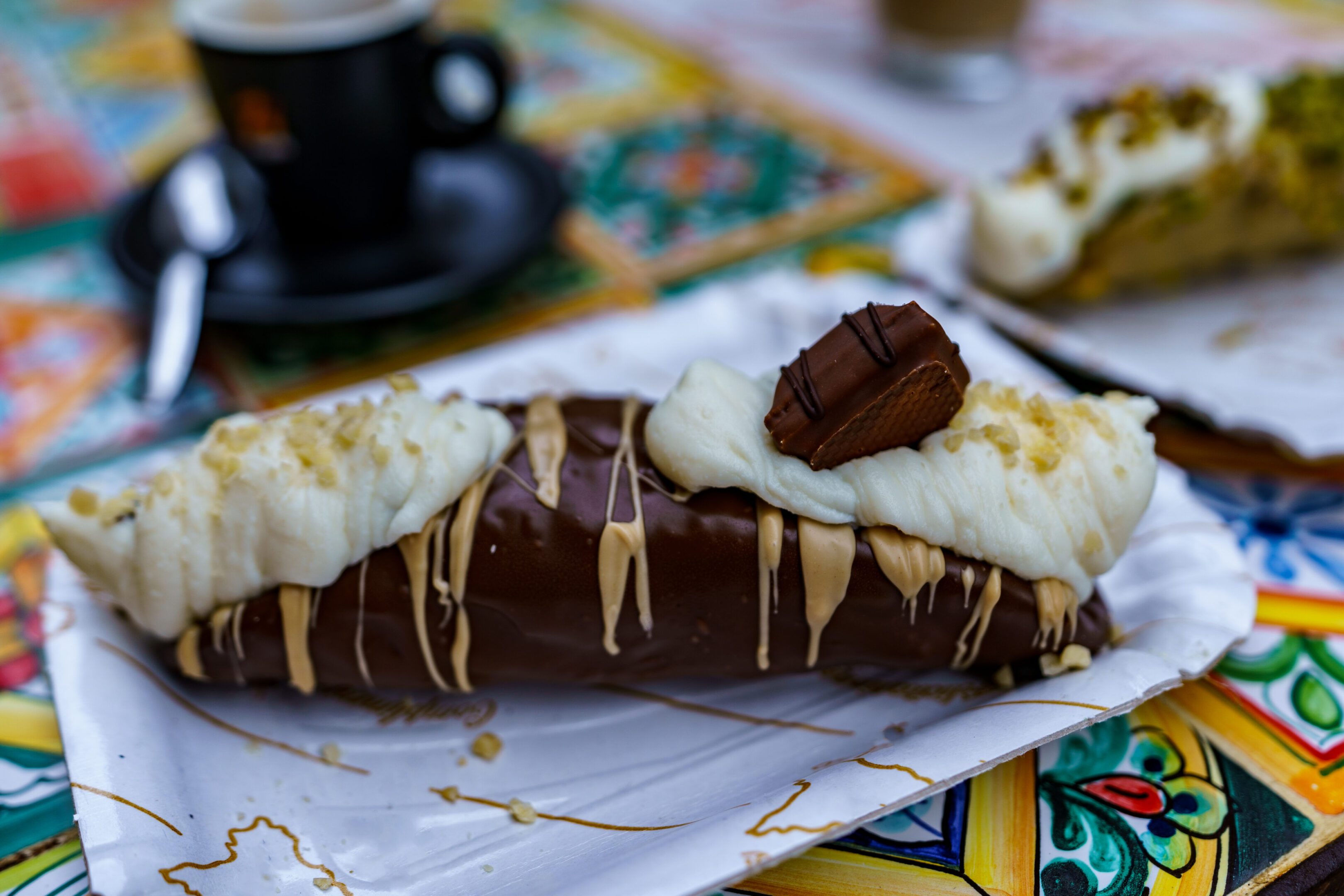 A pastry with white frosting and chocolate on top.