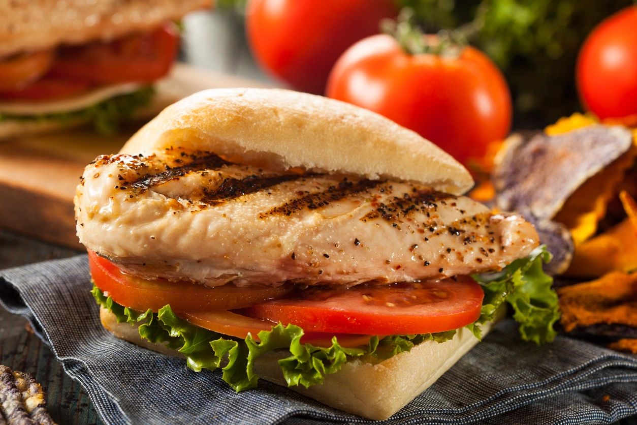 A sandwich with meat and tomatoes on it.